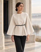 Margaux ivory stand-collar cape beside a misty riverside pavilion